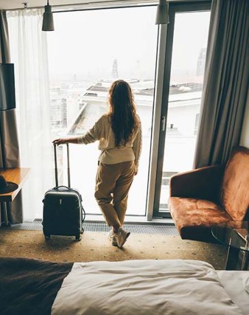A female traveler in the hotel room